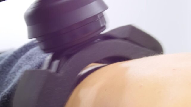 Professional body shaping therapy with vibromassage thermo vacuum and bioelectrical stimulation in beauty salon. 