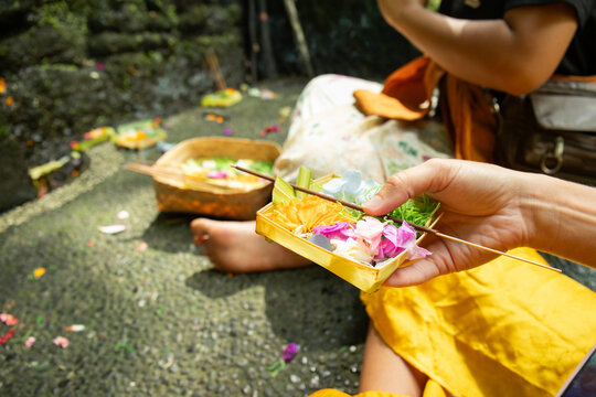 Canang sari. Woman holding colorful canang sari, space for text