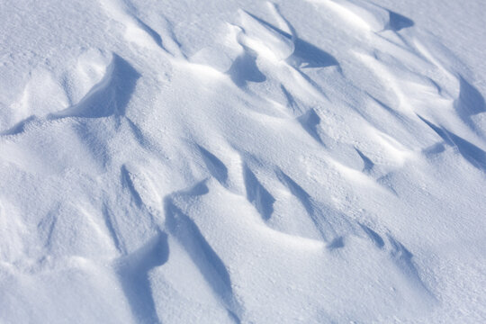 A snow covered ground with a few snowflakes