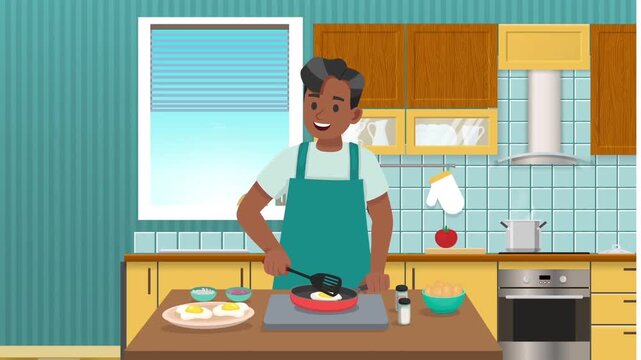 Smiling young man wearing green apron cooking fried eggs in kitchen during morning breakfast preparation