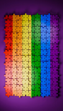 Rainbow colored jigsaw puzzle pieces assembled on purple background