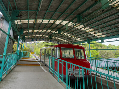 Takamatsu, Kagawa prefecture, Japan - April 16, 2018: Yakuri Cable funicular wagon stopped at the station on a slanted mountain slope