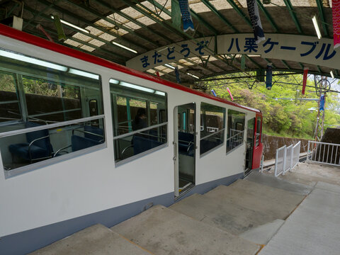 Takamatsu, Kagawa prefecture, Japan - April 16, 2018: Yakuri Cable funicular wagon stopped at the station on a slanted mountain slope