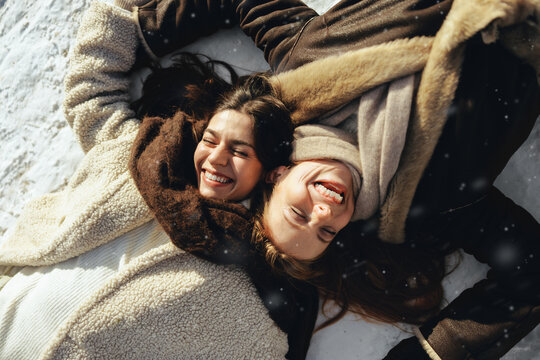 Playful friendship enjoys winter fun in the snow