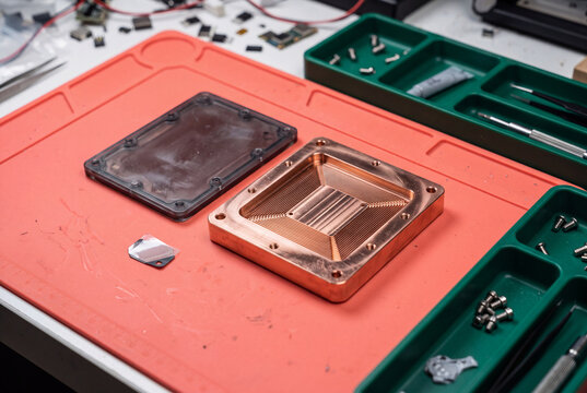 Copper water cooling block and acrylic cover on electronics repair bench