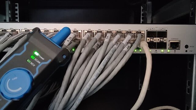 A network tester acts as a digital physician checking the vital pulse of the internet's nervous system, diagnosing the tangled data arteries of a server room switch to ensure seamless connectivity.