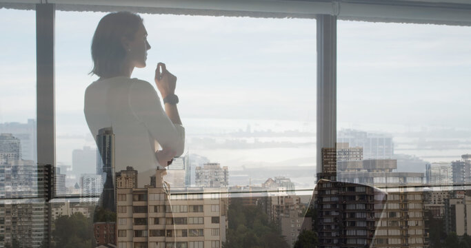 Image of thoughtful caucasian businesswoman over cityscape