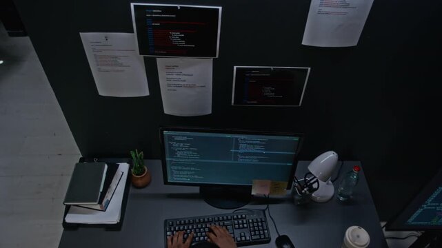 Specialist typing code on desktop computer keyboard from top angle. Ideal for software development tutorials, IT promos, and tech projects