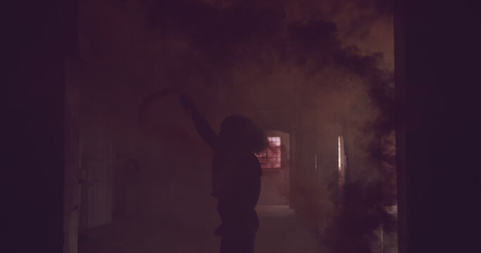 Silhouetted figure in a smoky room, with copy space