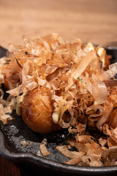 Japanese takoyaki octopus balls served on a sizzling skillet