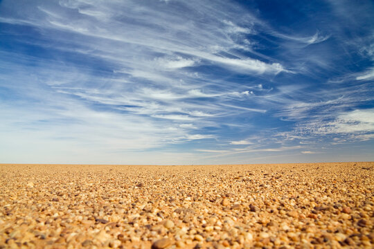 Stony terrain under cloudy sky in libyan desert Sahara North Africa