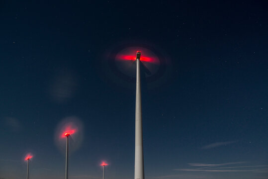 Wind turbines spinning at night in Rhade, North Rhine-Westphalia