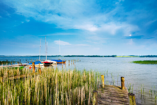 Lake hemmelsdorf with boats docked at a wooden pier