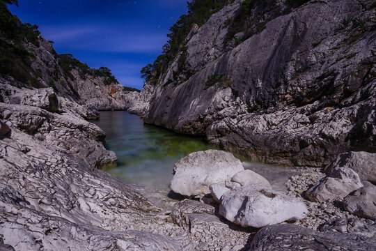 Portu pedrosu rocky coastal inlet under full moon in Sardinia Italy