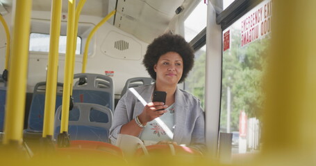 Happy plus size woman using smartphone in bus © WavebreakMediaMicro