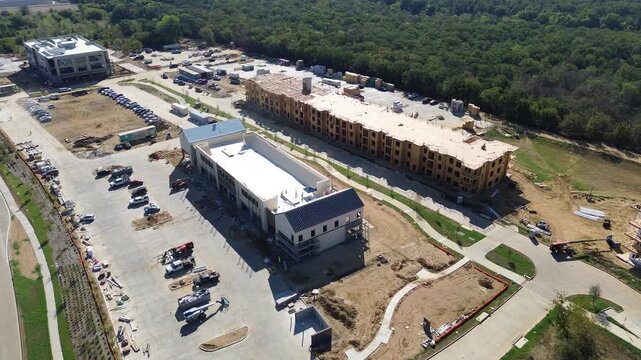 Building foundations establish near Silveron Boulevard. Excavated trenches, mixed tree canopy outdoor environment, Flower Mound, Texas