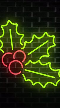 Vertical video: Neon holly sign powering on, glowing, casting halo on bricks, showing holiday cheer