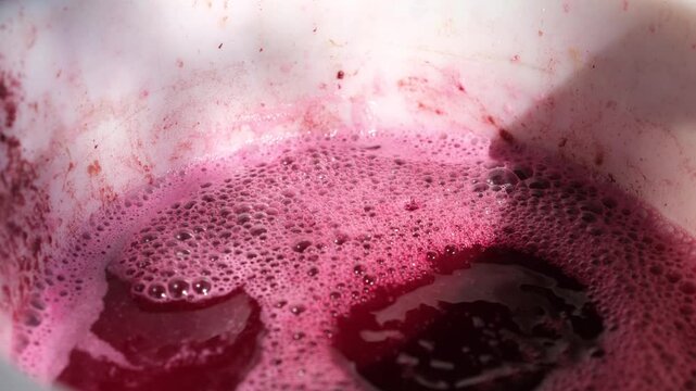 Wine-making process. Must flow in a special container. Traditional technology. Selective focus.
