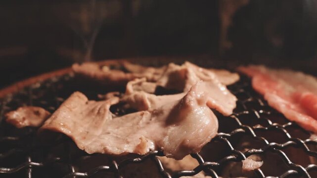 Grilled meat steak on stainless grill depot with flames on dark background. Food and cuisine concept. Copy space image. Place for adding text or design