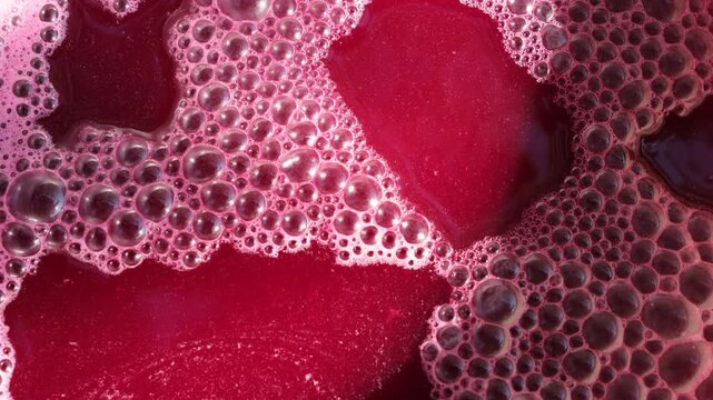 Active fermentation bubbles on the must surface. Winemaking Process. Top view.