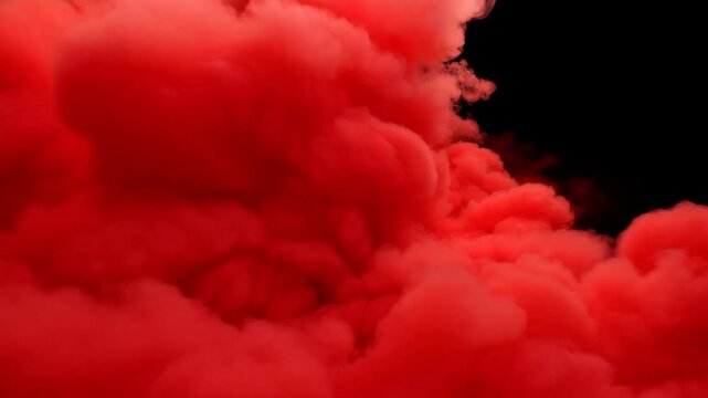 Red smoke cloud forms a dense abstract shape against a solid black background