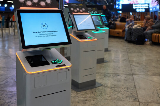 Self-service check-in kiosk unavailable error screen in airport terminal. Out of service terminal, system failure, flight disruption, airport outage, and technology error concept