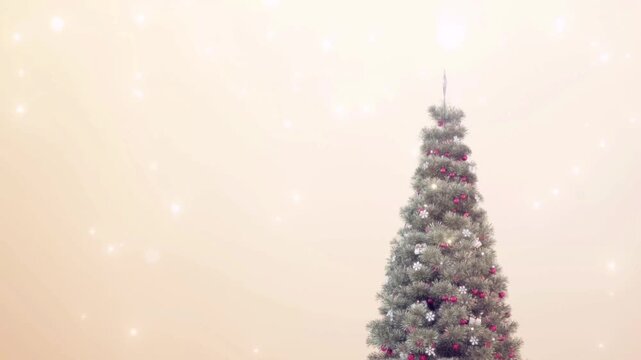 A beautiful, elegantly decorated Christmas tree on the right side of the screen, set against a soft cream-colored background with shimmering light effects and gently falling snowflakes.