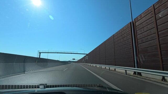 Driving Past Tall Noise Barriers on Highway Near Bratislava, Slovakia