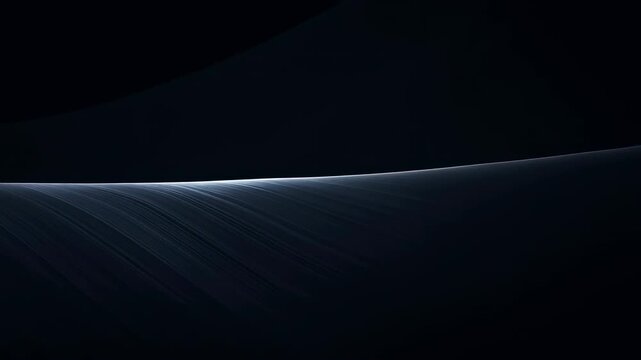 Dark rippled surface shifts slowly beneath blue-white light tracing gently curved ridge, with fine diagonal textures fading into shadow and ample black copy space above
