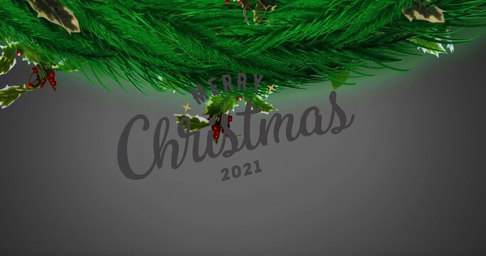 Framing pine garland, holly with berries along top edge of holiday card, with Merry Christmas 2021