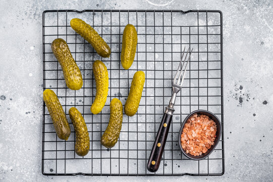 Crunchy pickled cucumbers, bursting with flavor, perfect for sandwiches, salads, or as a tangy snack. grey background