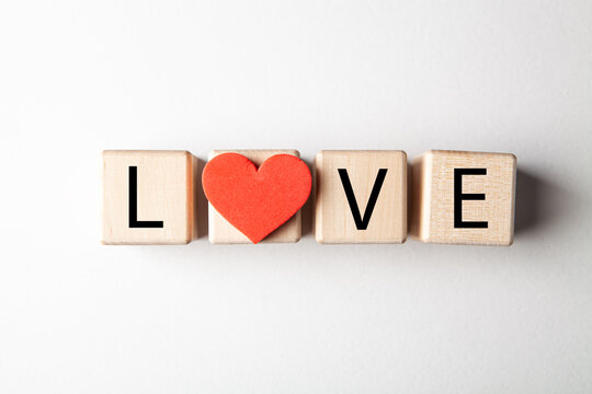 Love text on wooden cubes on white background, valentine concept