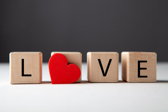 Love text on wooden cubes on white background, valentine concept