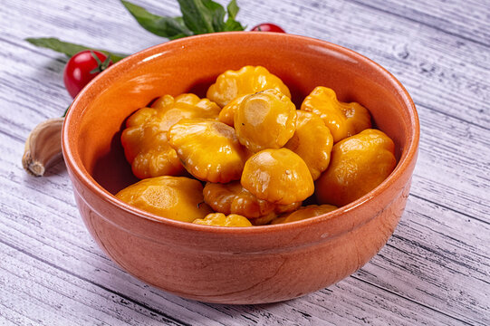 Clay bowl, yellow patisson squash, pickled vegetable snack