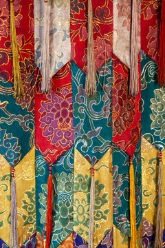Detail of colorful brocade silk banners with tassels at Yuru Monastery, Ladakh, Lamayuru, India