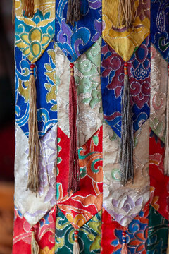 Close up of brocade silk hangings with lotus patterns and tassels at Yuru Monastery, Ladakh, Lamayuru, India