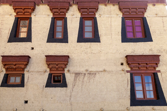 Facade with traditional windows with painted lintels and dark painted frames, Ladakh, Leh, India