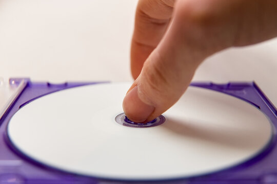 Taking a CD from a purple CD case