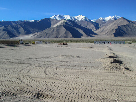 Vast desert landscape with snow-capped mountains in the background