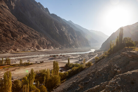 Backlit mountain valley with a river and poplar trees on the slopes, Ladakh, Turtuk, India