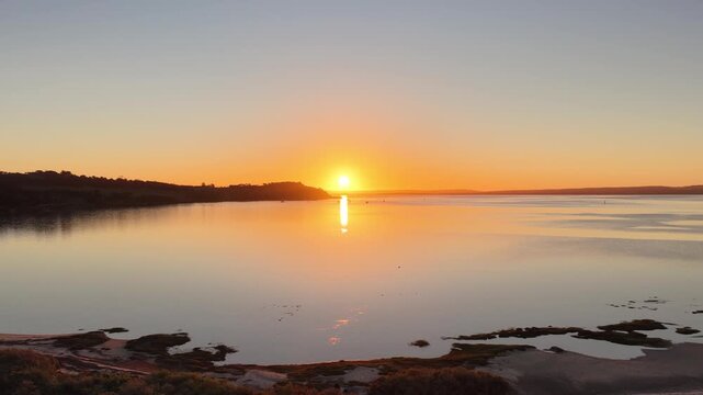 Kingscote, Kangaroo Island, South Australia &ndash; 4K aerial drone view of golden sunset over Bay of Shoals and North Cape from Reeves Point, fishing boats and marina, peaceful bay, glowing sea reflections