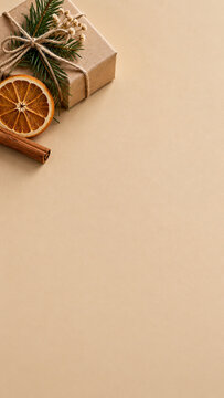 Christmas Gift with Natural Elements: A rustic kraft paper gift box tied with twine and adorned with a sprig of evergreen, a dried orange slice, and a cinnamon stick evokes a warm.
