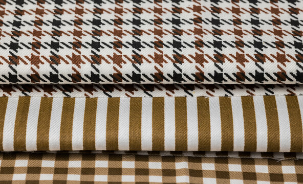 Folded fabrics with houndstooth, stripes, and gingham patterns