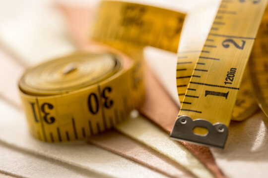Yellow measuring tape on fabric for sewing and tailoring