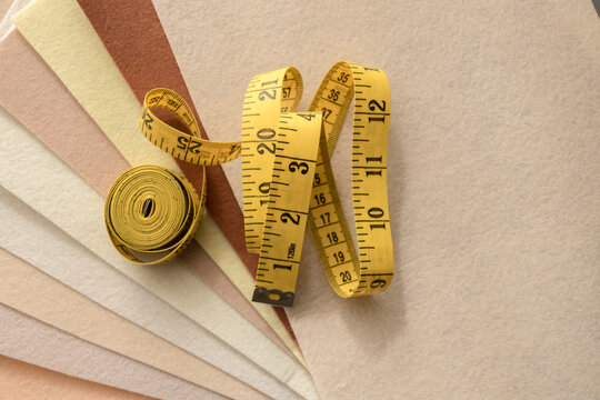 Yellow measuring tape on layered felt fabric swatches
