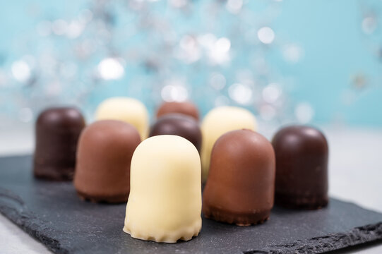 Chocolate teacakes, coated marshmallow treats, krembo, pastry sweets with cookies, fluffy cream and glaze, traditional winter dessert, food selection
