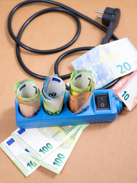 Electricity power socket with Euro banknotes, high expensive energy price, economy crisis, money for paying bill, increase costs of living, inflation and social issues
