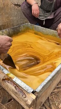 Traditional Gur Making Process with Boiling Sugarcane Juice in a Large Metal Pan