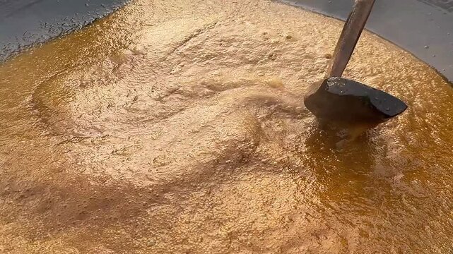 Traditional Gur Making Process with Thick Golden Jaggery Syrup in Rural Production
