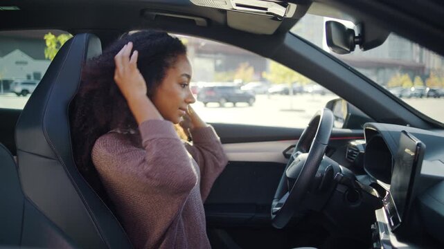 Woman gets on car preparing driver seat before starting trip